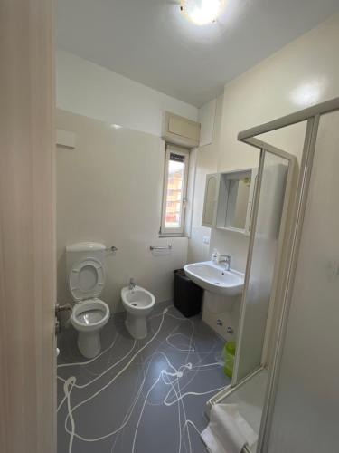 a bathroom with a toilet and a sink at Macloud pub B&B in Sarnico