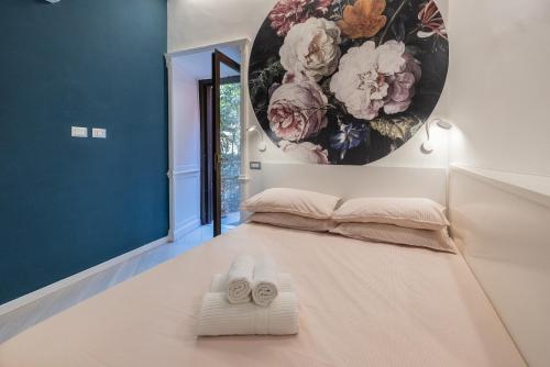 a room with a bed and two slippers on the floor at Rione Monti Studio Apt with private garden in Rome