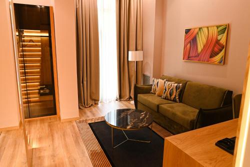 a living room with a couch and a table at White Hill Hotel, SPA & Conferences in Durrës
