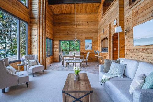 a living room with a couch and a table at Oceanfront Retreat, Mount Rainier, King bed, Games in Longbranch