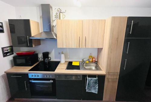 a small kitchen with a sink and a stove at Ferienwohnung Burgblick in Schramberg