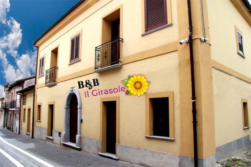a building with a sunflower sign on the side of it at B&B IlGirasole in Paravati
