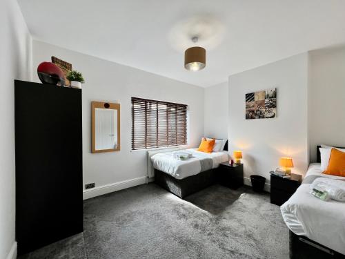 a bedroom with two beds and a window at Johnson House - Charm Townhouse in Cleethorpes