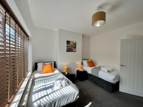 a bedroom with two beds and a window at Johnson House - Great for Contractors or Family Holidays in Cleethorpes