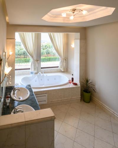 a large bathroom with a tub and a window at Villa Belvedere in Alexandroupoli