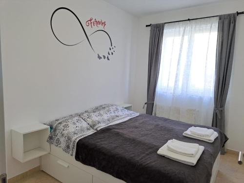 A bed or beds in a room at Apartman Lunna