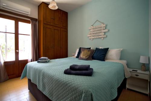 a bedroom with a bed with two towels on it at Nicola's Apartments in Kassiopi