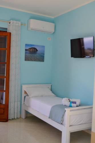 a bedroom with a white bed and a tv at Le Twins -Bed and Breakfast in Tropea