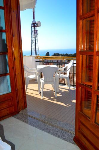 a view of a table and chairs on a balcony at Le Twins -Bed and Breakfast in Tropea