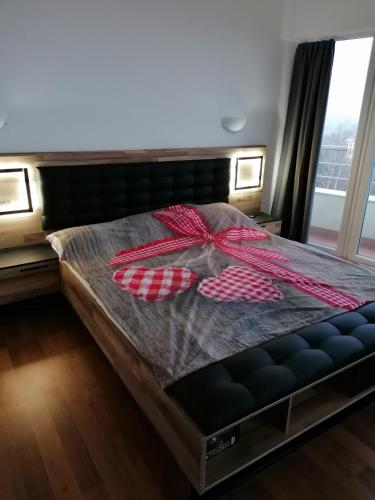 a bed with a red bow on top of it at Sun Gates Byala in Byala