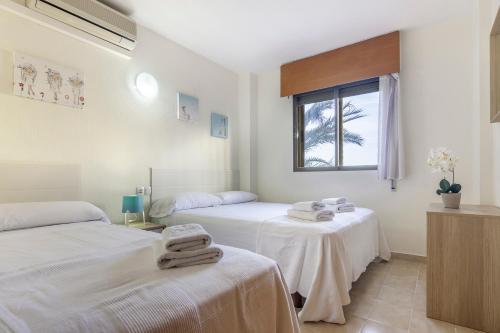 En eller flere senger på et rom på Villas Guzman - Apartamento Trond Paraiso Mar