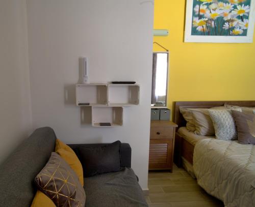 a living room with a couch and a bed at Nicola's Apartments in Kassiopi
