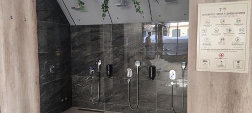 a glass shower in a building with a sign on the wall at Mountain Eyes Titova vila in Palisad