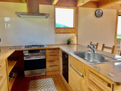a kitchen with a sink and a stove at Kitaarupusu ichibō no ie - Vacation STAY 96488v in Omachi