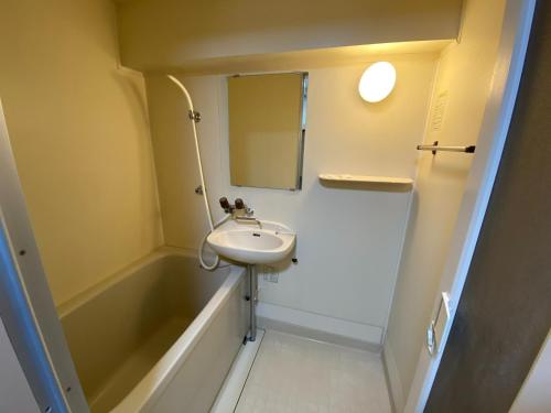 a bathroom with a sink and a bath tub at Royal Heights Chuocho - Vacation STAY 12751 in Kagoshima