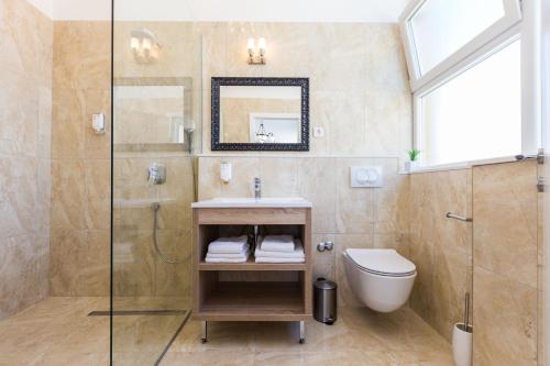 a bathroom with a shower and a sink and a toilet at B&B Giardin exclusive rooms and suite in Zadar