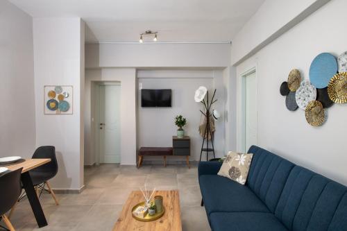 a living room with a blue couch and a table at Silvia's Apartments in Corfu Town
