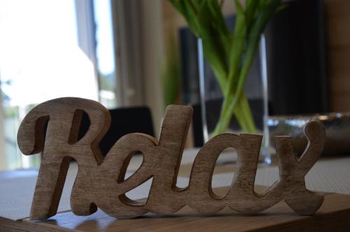 a wooden sign for the wordax sitting on a table at Visit sauna Klinovec in Loučná pod Klínovcem