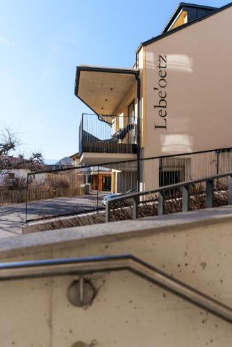 a building with a sign on the side of it at Lebe`oetz - Das Ferienapartmenthaus im Zentrum von Oetz in Oetz