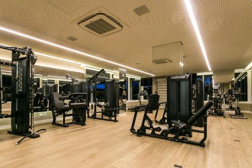 a gym with several treadmills and machines in a room at Gym | Food Hall | 450m from the mall #CA04 in Florianópolis