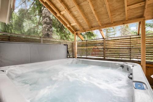 a hot tub in a sauna with a window at Mountain Rose in Government Camp