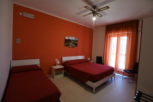 a bedroom with two beds and a ceiling fan at Bed and breakfast Coppadicuocobb in Mattinata