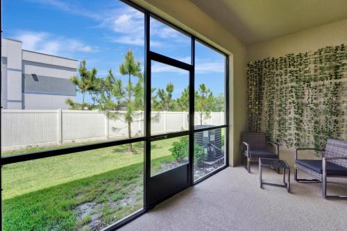 a living room with large windows and a view of a yard at ZenHomes in heart of Brandon convenient location in Brandon
