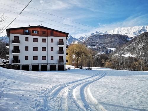 a building in the snow with tracks in the snow at Feel like Home - vista montagna, vicino lago di Como in Maggio