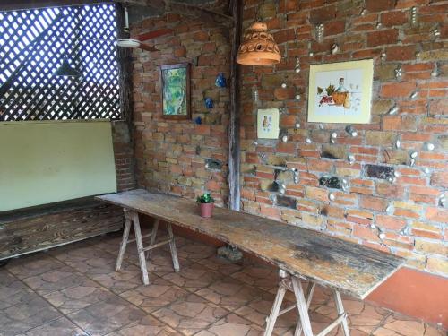 a wooden bench sitting against a brick wall at Hosteria Helvecia in Montecarlo