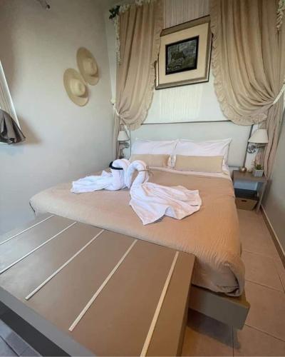 a bedroom with a bed with a robe on it at Seaview apartment in Tsoútsouros