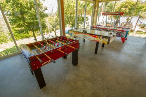 two ping pong tables in a room with windows at Itá Thermas Resort e Spa in Itá