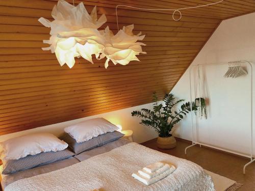 a bedroom with a bed and a wooden ceiling at Lakeview Guesthouse & Chalet Bled in Bled