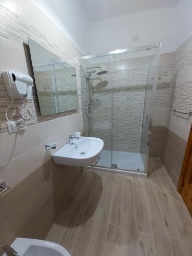 a bathroom with a toilet and a sink and a shower at Le Twins -Bed and Breakfast in Tropea