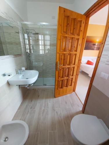 a bathroom with a toilet and a sink at Le Twins -Bed and Breakfast in Tropea