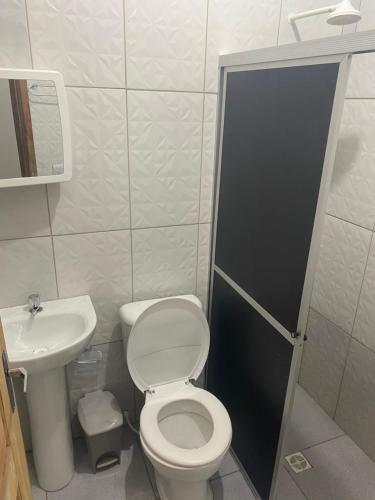 a small bathroom with a toilet and a sink at Hotel SANTA CLARA in Belém