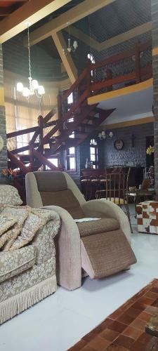 a living room with a couch and a table at Casa de Pedra-Vale dos Vinhedos -RS in Monte Belo