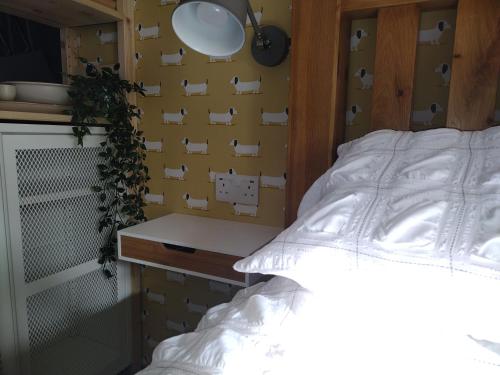 a bedroom with a white bed and a yellow wall at Dunseverick Ramblers Rest in Bushmills