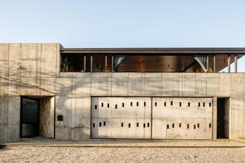 a building with two garage doors on the side of it at Flavia Hotel in Oaxaca City