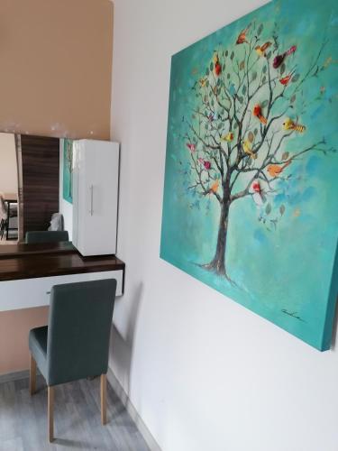 a painting of a tree with birds on it at ΕΚΑLI ROOMS APARTMENTS in Kalentzi