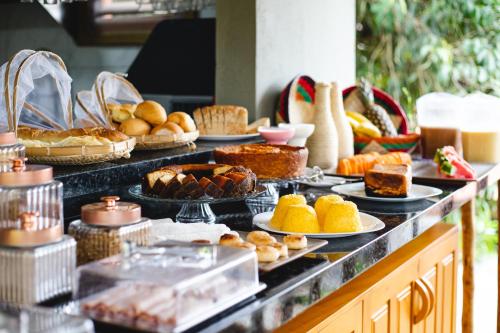 a buffet line with pies and pastries and other foods at UNKUÉ POUSADA FLATS in Jericoacoara
