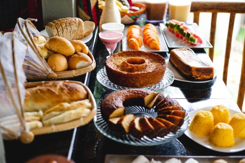 a table full of different types of bread and pastries at UNKUÉ POUSADA FLATS in Jericoacoara