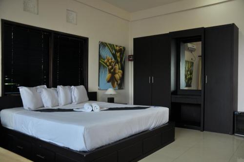 a bedroom with a large bed with white sheets at Crystal Beach Bali in Candidasa