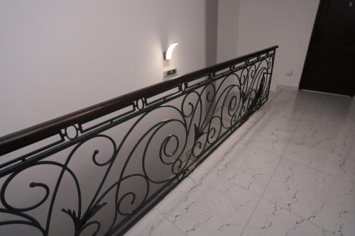 a black metal railing in a room with a tile floor at CENTRAL VIEW Craiova in Craiova