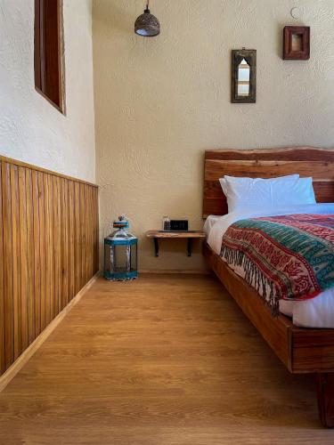 a bedroom with a bed and a night stand next to it at La Hault in Sissu