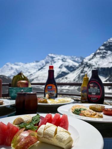 a table with plates of food and bottles of beer at La Hault in Sissu