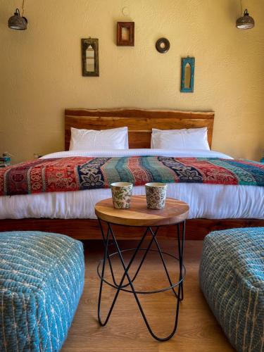 a bedroom with two beds and a table with two cups at La Hault in Sissu