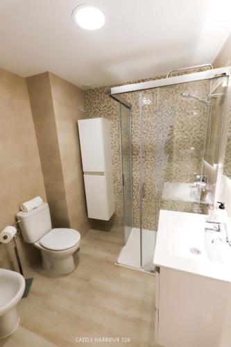 a bathroom with a toilet and a shower and a sink at CH 524 Sea View in Los Cristianos