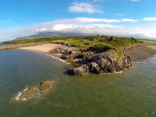 an aerial view of a rocky island in the ocean at Herdwicks in Millom