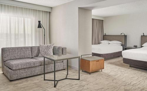 a hotel room with a couch and a bed at Hyatt Regency Deerfield in Deerfield