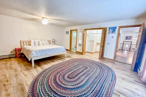 a bedroom with a bed and a large rug at Summertime in Bar Harbor